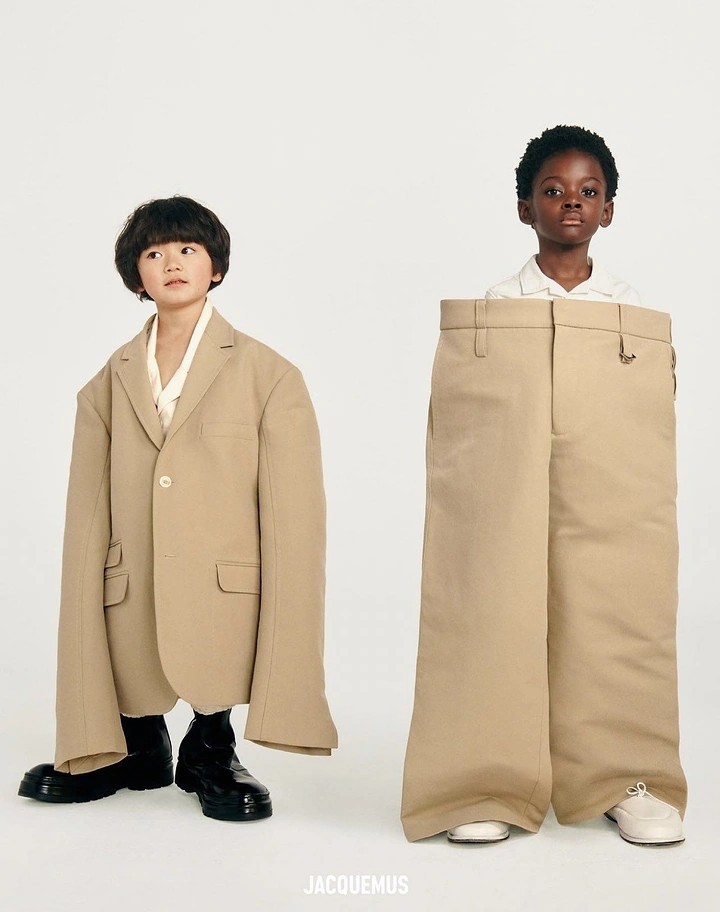 Fashion creative ad: Two children in hugely oversized beige blazer and trousers