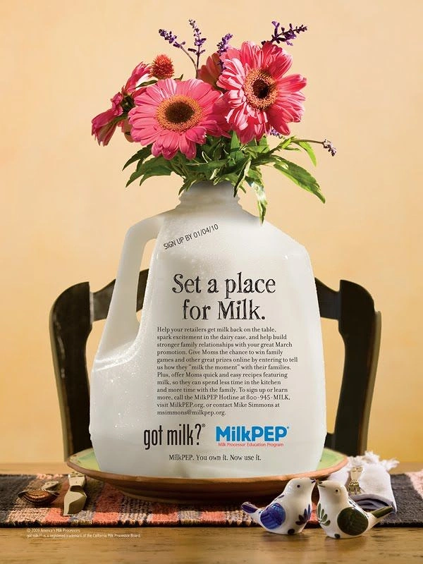 Dairy Brands creative ad: Milk jug as flower vase, place setting