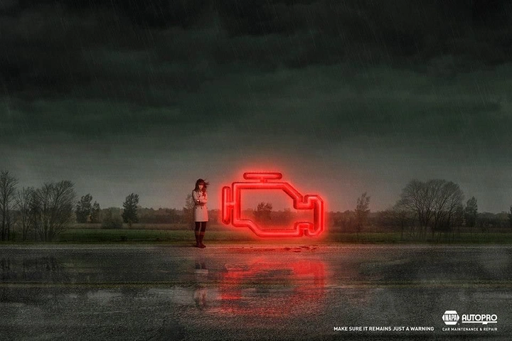 Auto Repair & Garages creative ad: Giant neon check-engine light looming