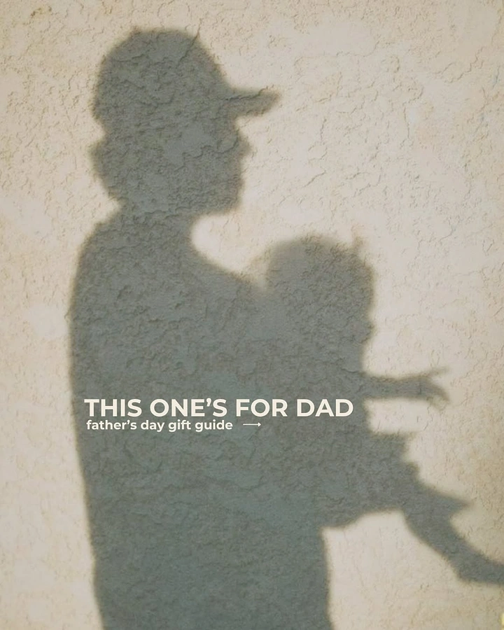 Father's Day creative ad: Shadow of a father in a cap holding a child on a wall