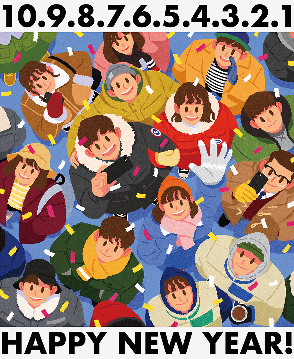 Top-down view of a smiling winter-clad crowd looking up amid confetti