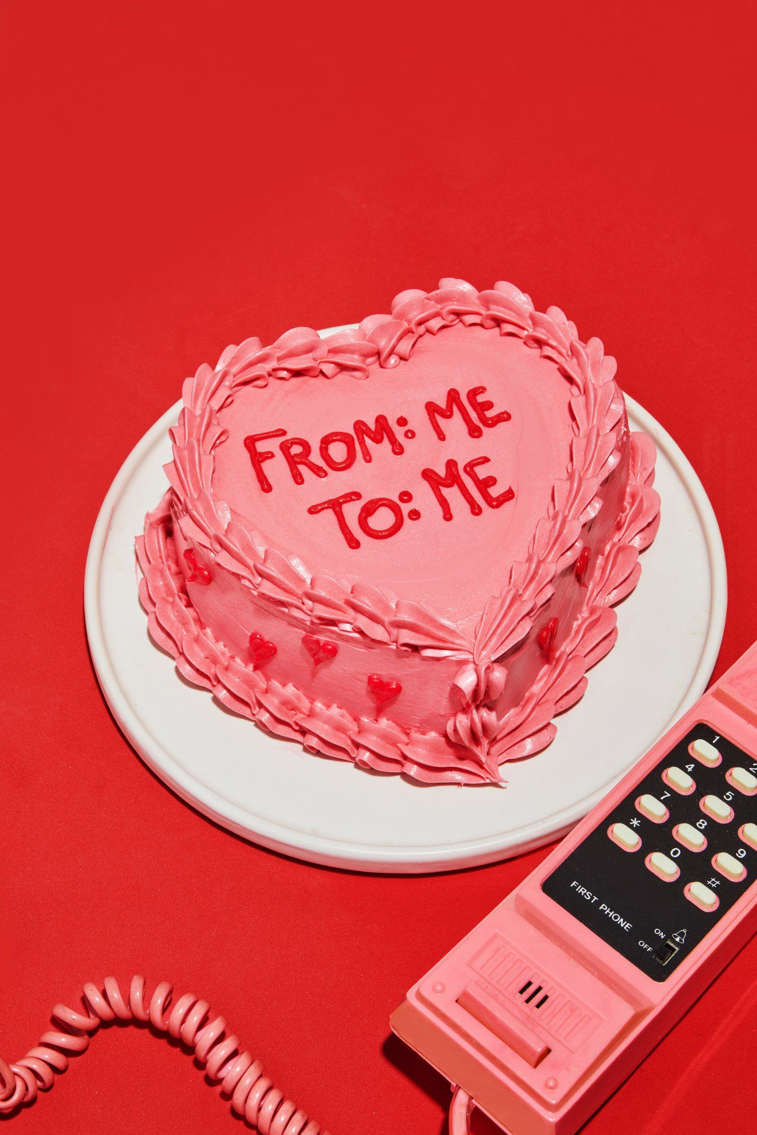 Valentine's Day Poster: Pink heart cake beside a retro pink phone