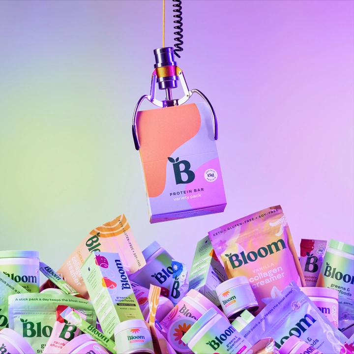 Creative ad: Arcade claw lifting a protein bar box above a pile of supplement packs