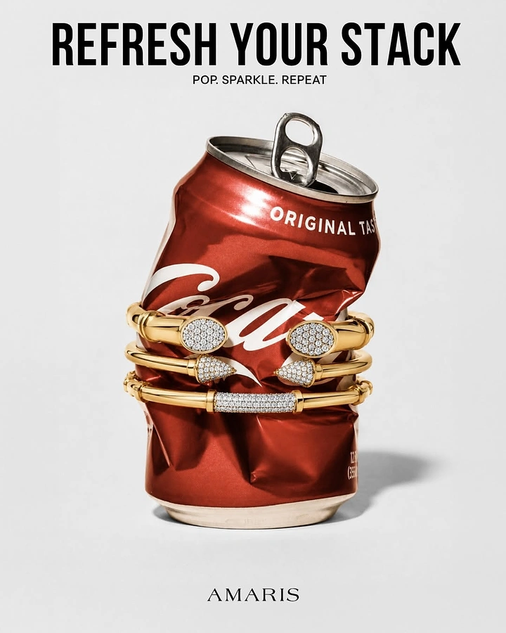 Jewellery creative ad: Diamond gold bangles stacked around a crushed red soda can