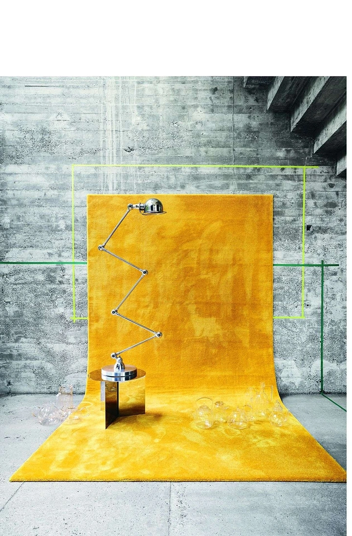 Rugs & Carpets creative ad: Surreal yellow rug installation in industrial space