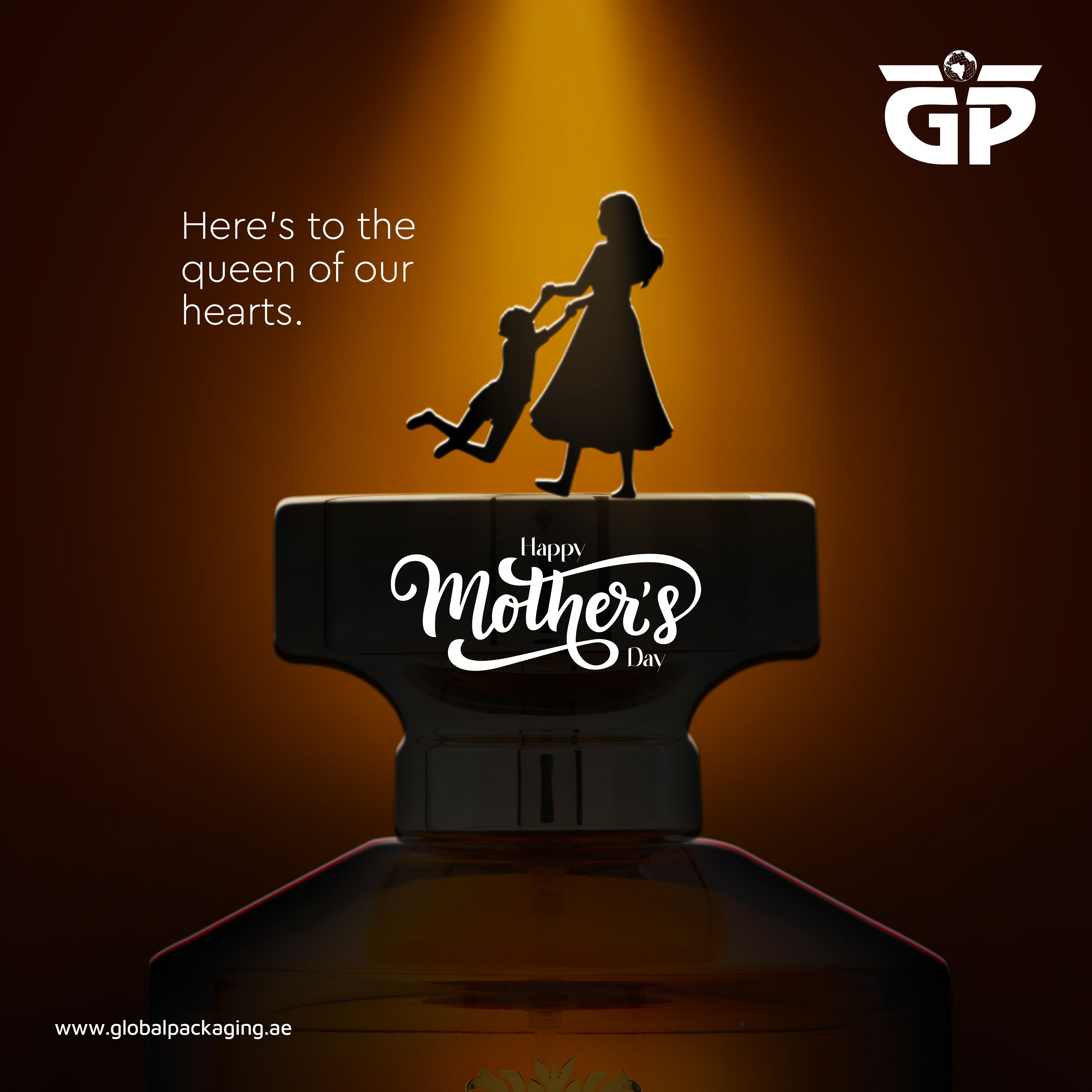 Mother-child silhouette atop a perfume bottle cap