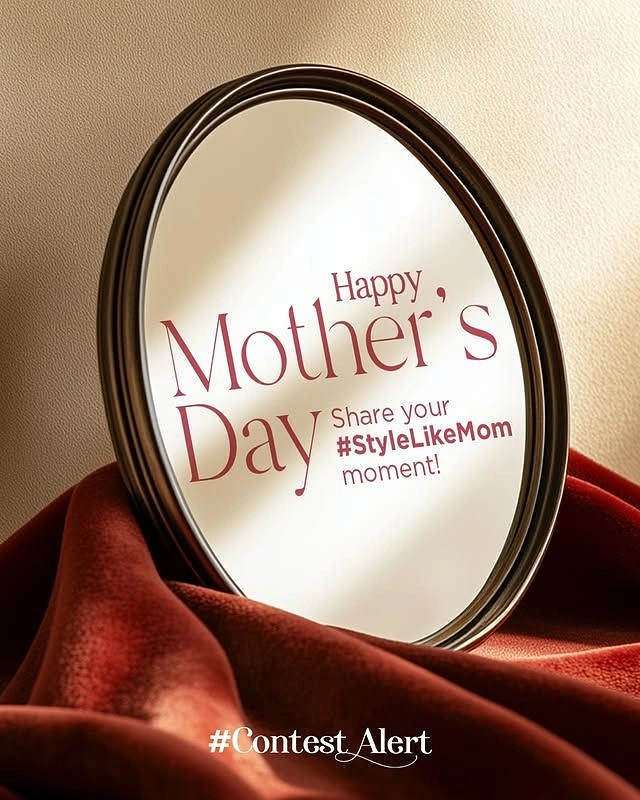 Mother's Day creative ad: Dark-framed oval mirror resting on rust velvet drapery