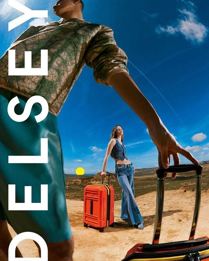 Creative ad: Forced-perspective models with suitcases in a desert