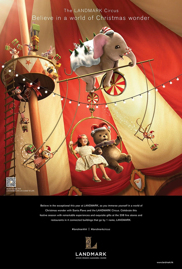 Christmas creative ad: Girl and teddy bear on a trapeze hoop under a Christmas circus big top