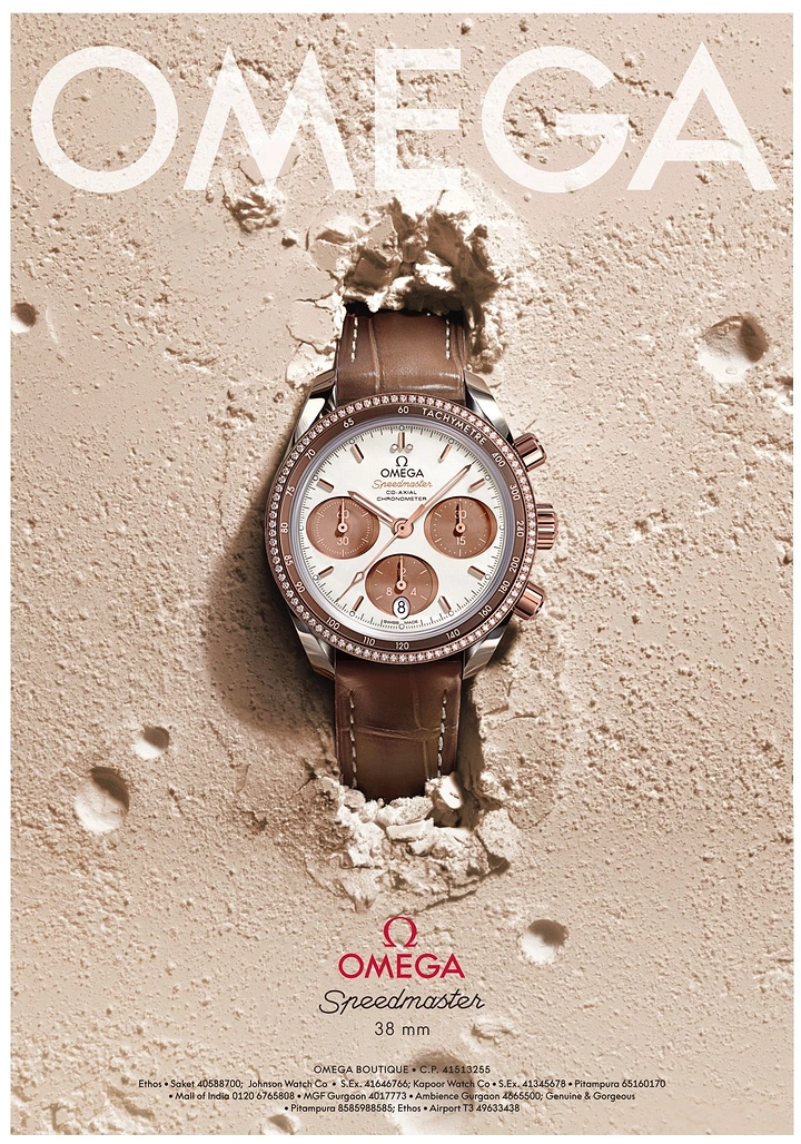 Creative ad: Diamond-set rose gold chronograph breaking out of a sand-coloured plaster wall