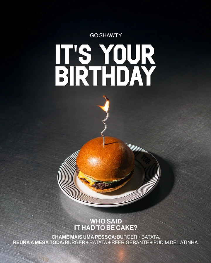 Fast Food creative ad: Burger with a lit spiral birthday candle on a plate