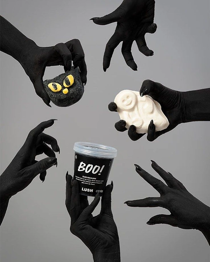 Halloween creative ad: Black-painted clawed hands grabbing Halloween bath products