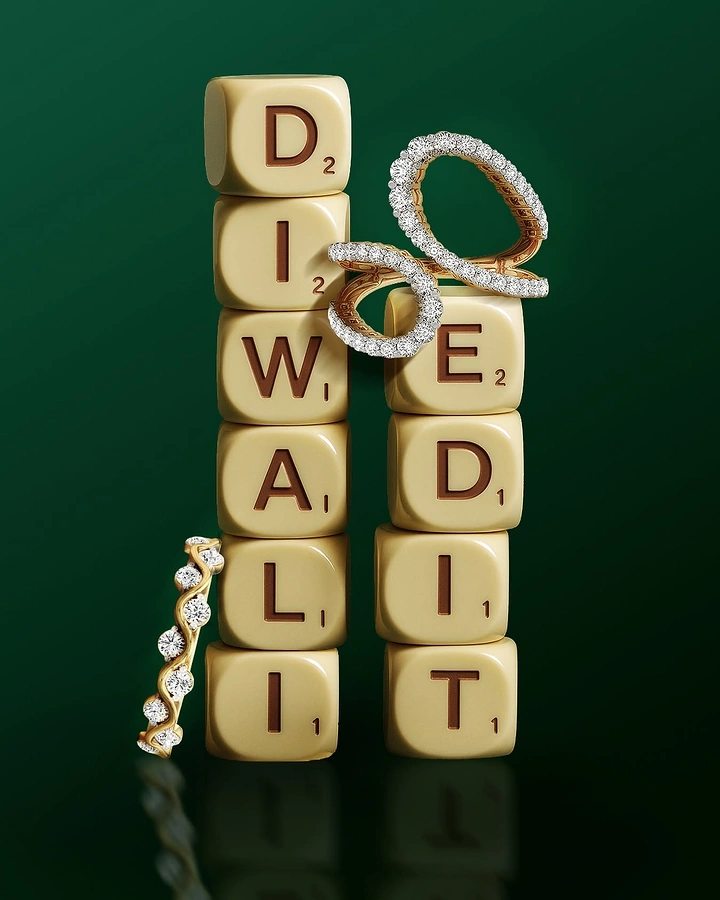 Diwali creative ad: Diamond jewelry arranged around cream letter tiles spelling Diwali