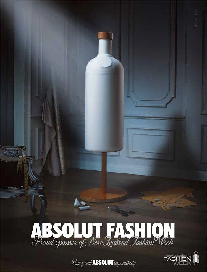 Creative ad: Bottle-shaped white tailor's dress form in a dim atelier