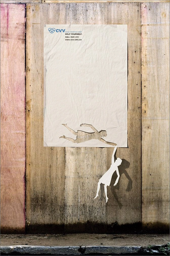 Nonprofit & Social Cause creative ad: A falling human figure reaching through a torn poster