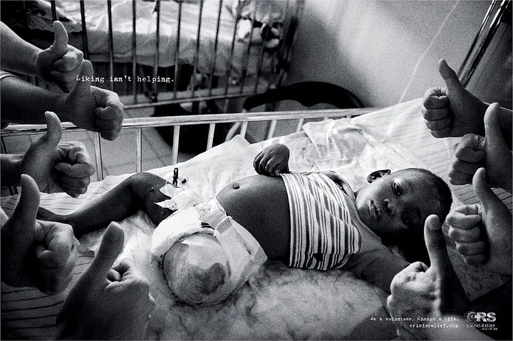 Creative ad: Injured baby in a hospital cot surrounded by thumbs-up hands