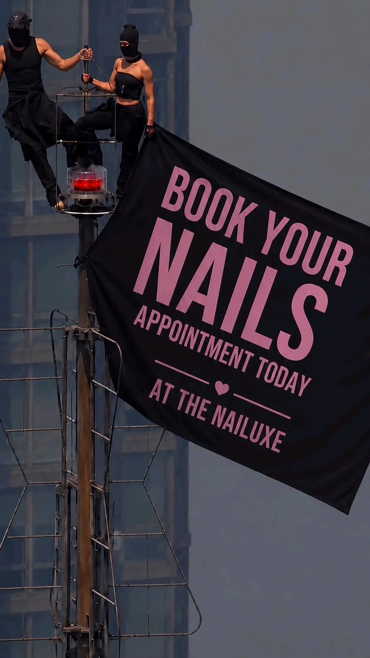 Nail Salons creative ad: Rooftop stunt banner hijack for booking CTA