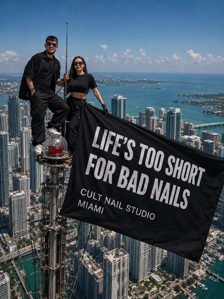 Nail Salons creative ad: Two people atop a skyscraper spire holding a giant black slogan flag