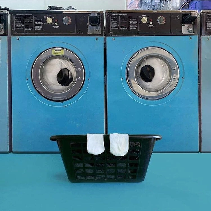 Laundry & Dry Cleaning creative ad: Washers and sock basket form a face