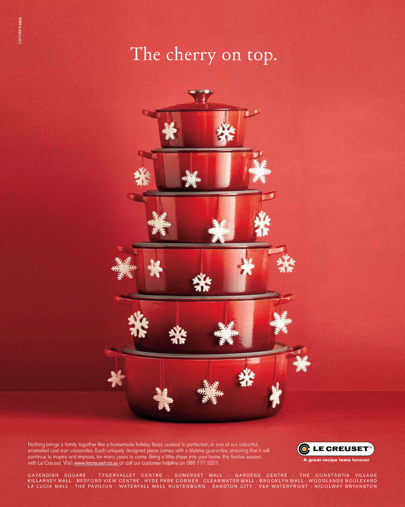 Christmas Poster: Stack of red cast-iron casseroles shaped like a Christmas tree with snowflakes