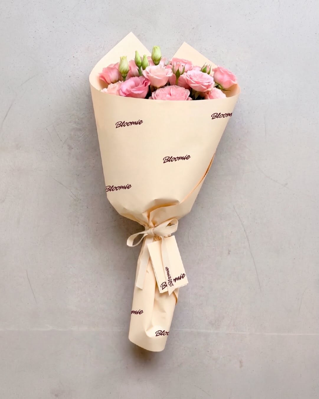 Bouquet carried in custom tote, bold script