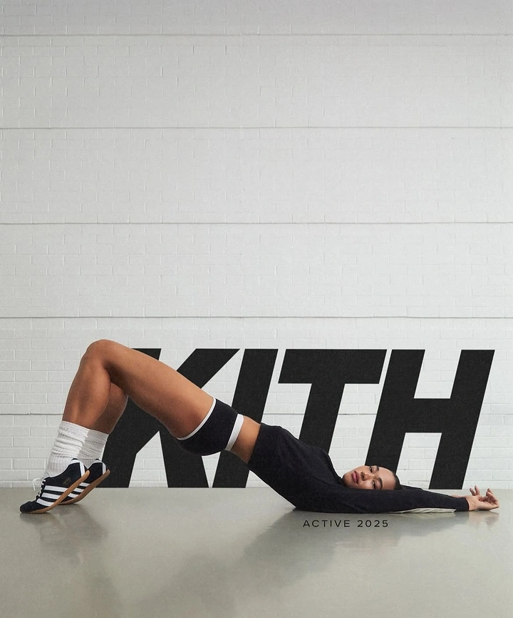 Creative ad: Woman in black activewear lying on floor in bridge pose before giant wordmark