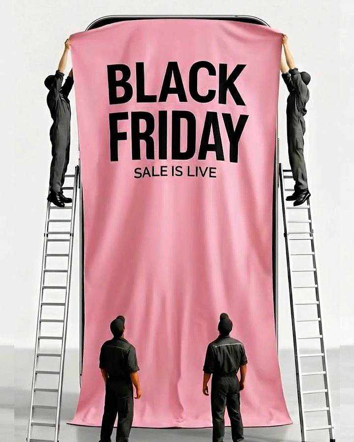 Black Friday creative ad: Workers on ladders unveiling a pink banner draped over a giant smartphone