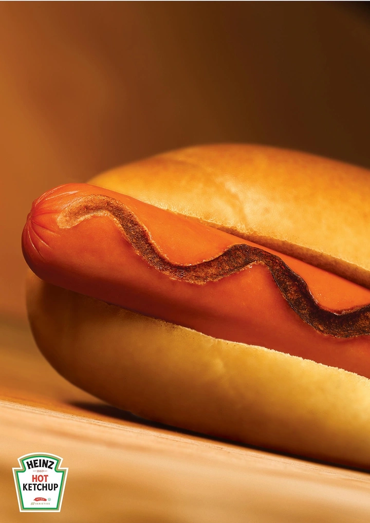 FMCG creative ad: Hot dog with a charred, burnt-looking ketchup squiggle
