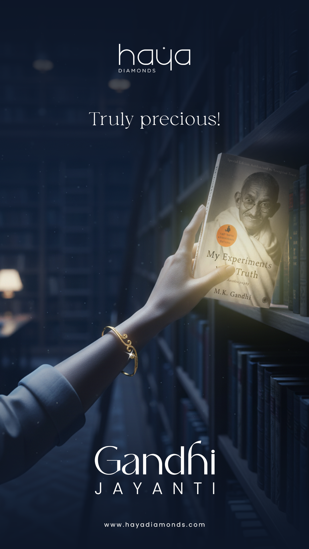 Hand with gold bangle pulling Gandhi's autobiography from a library shelf