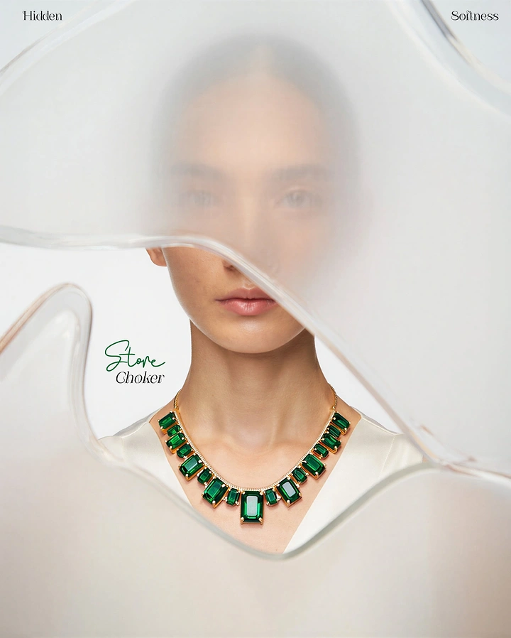 Creative ad: Model wearing an emerald and gold choker seen through a frosted glass cutout
