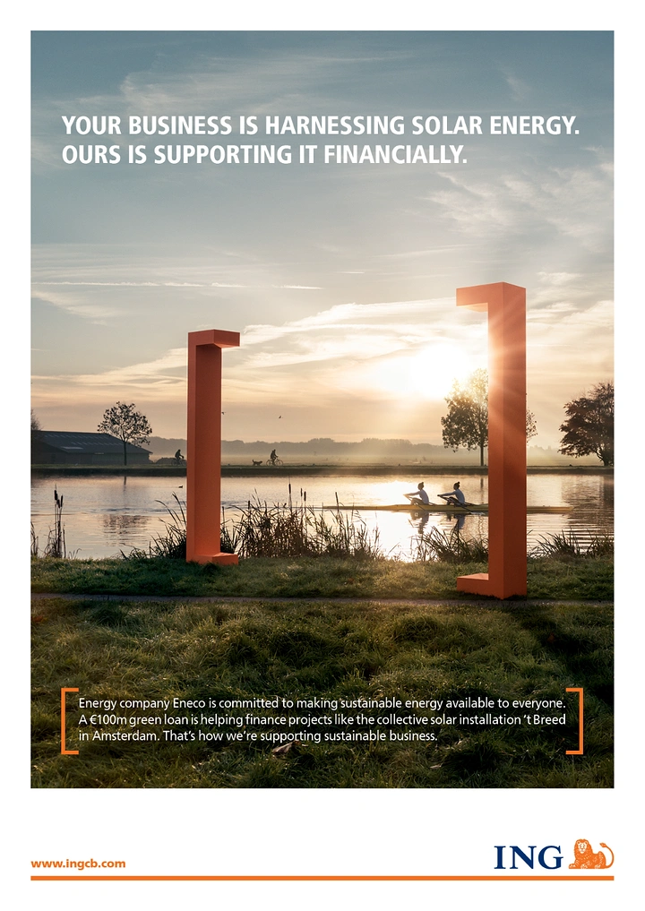 Solar & Energy creative ad: Giant orange bracket sculptures framing a sunrise river scene