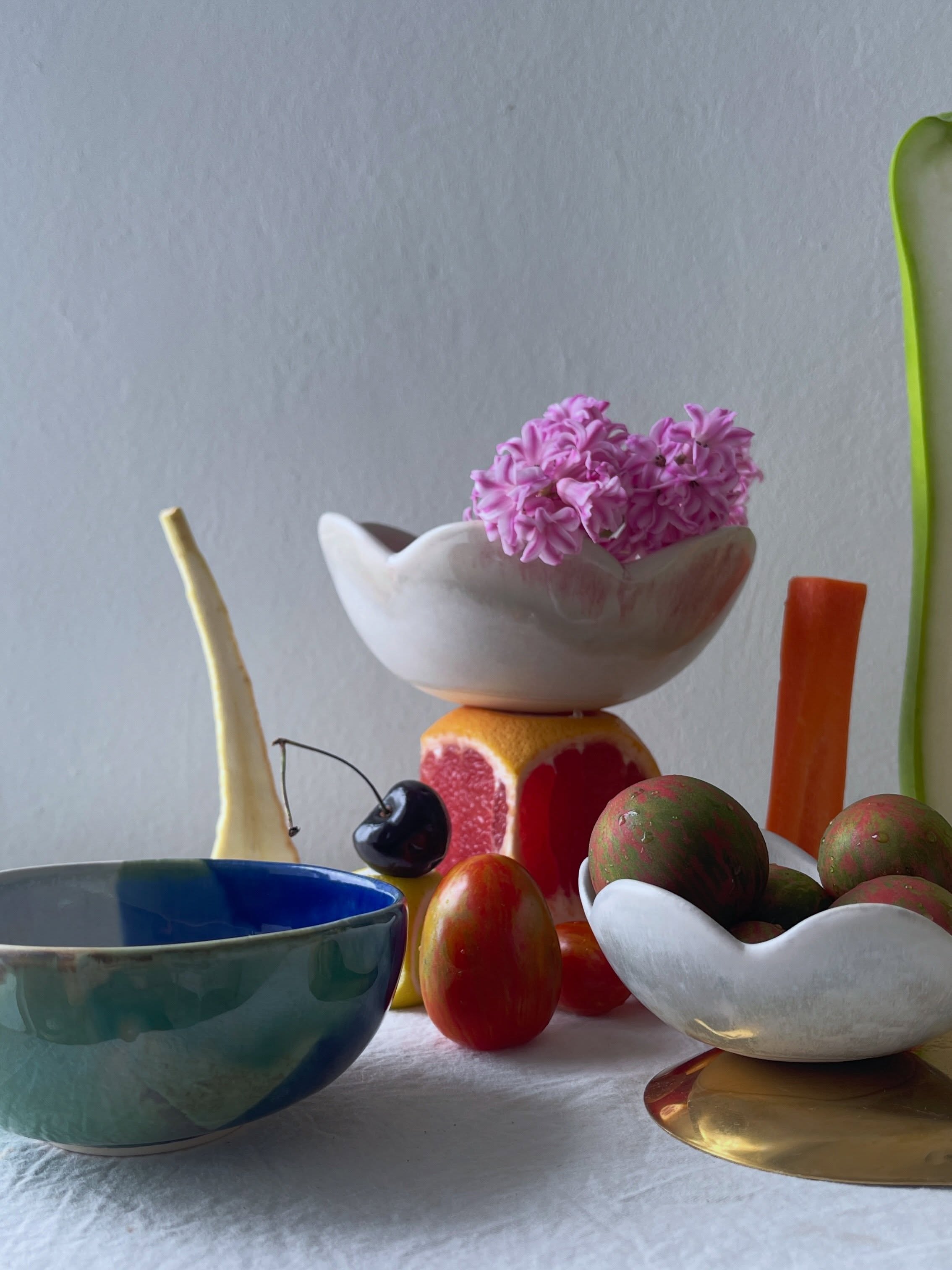 Carousel: An art-directed still life of fruit, flowers, and sculptural ceramic objects, slide 2