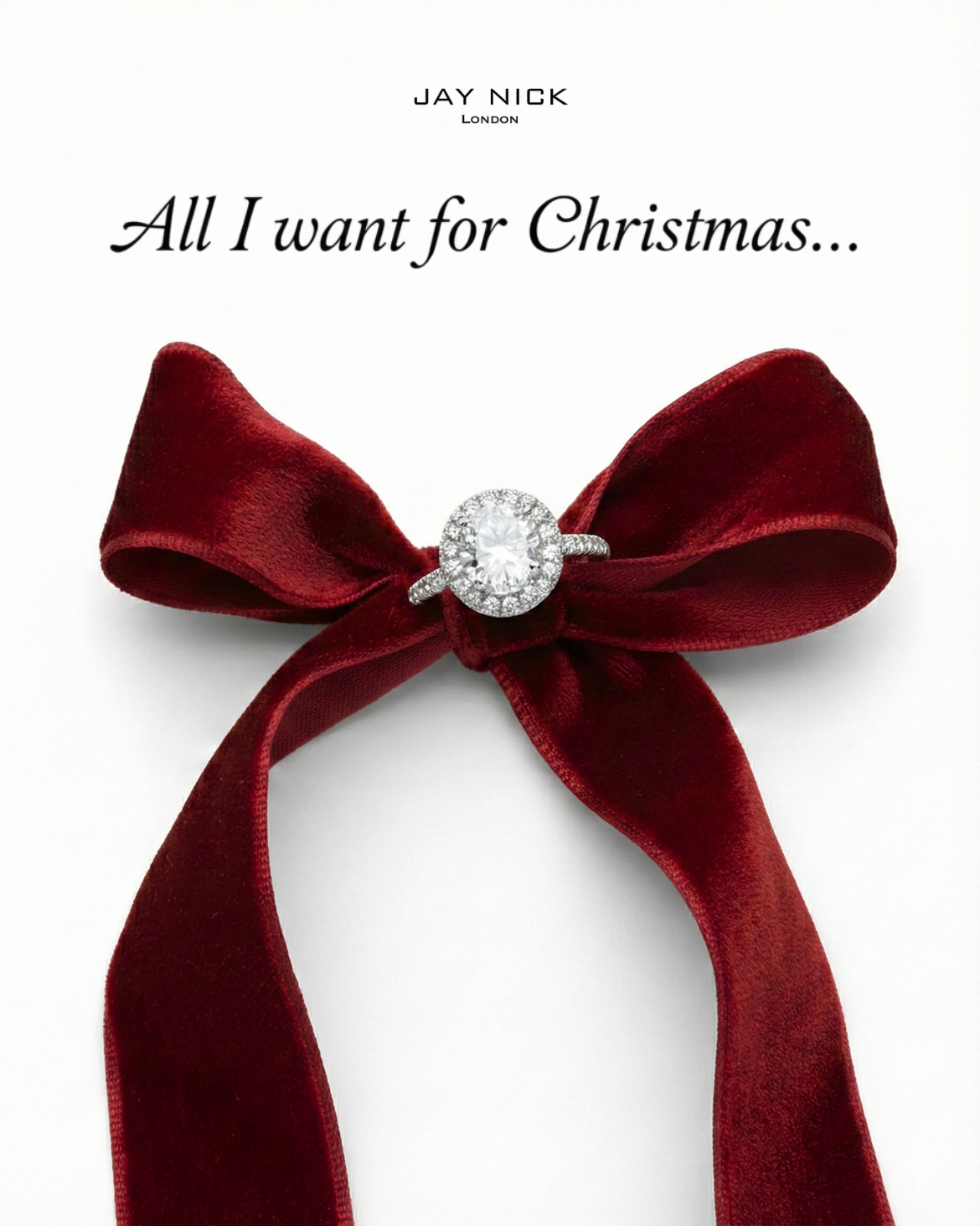 Diamond halo engagement ring tied at the centre of a red velvet bow