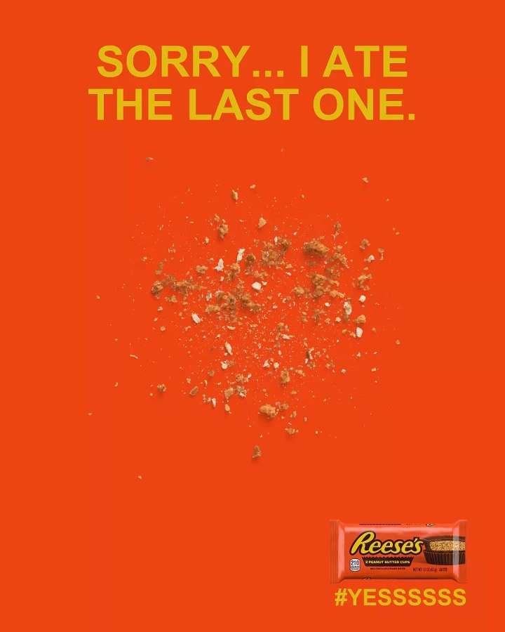 Creative ad: scattered chocolate and peanut butter crumbs on a flat orange background