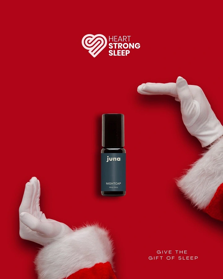 Christmas creative ad: Sleep oil roller bottle framed by Santa's gloved hands