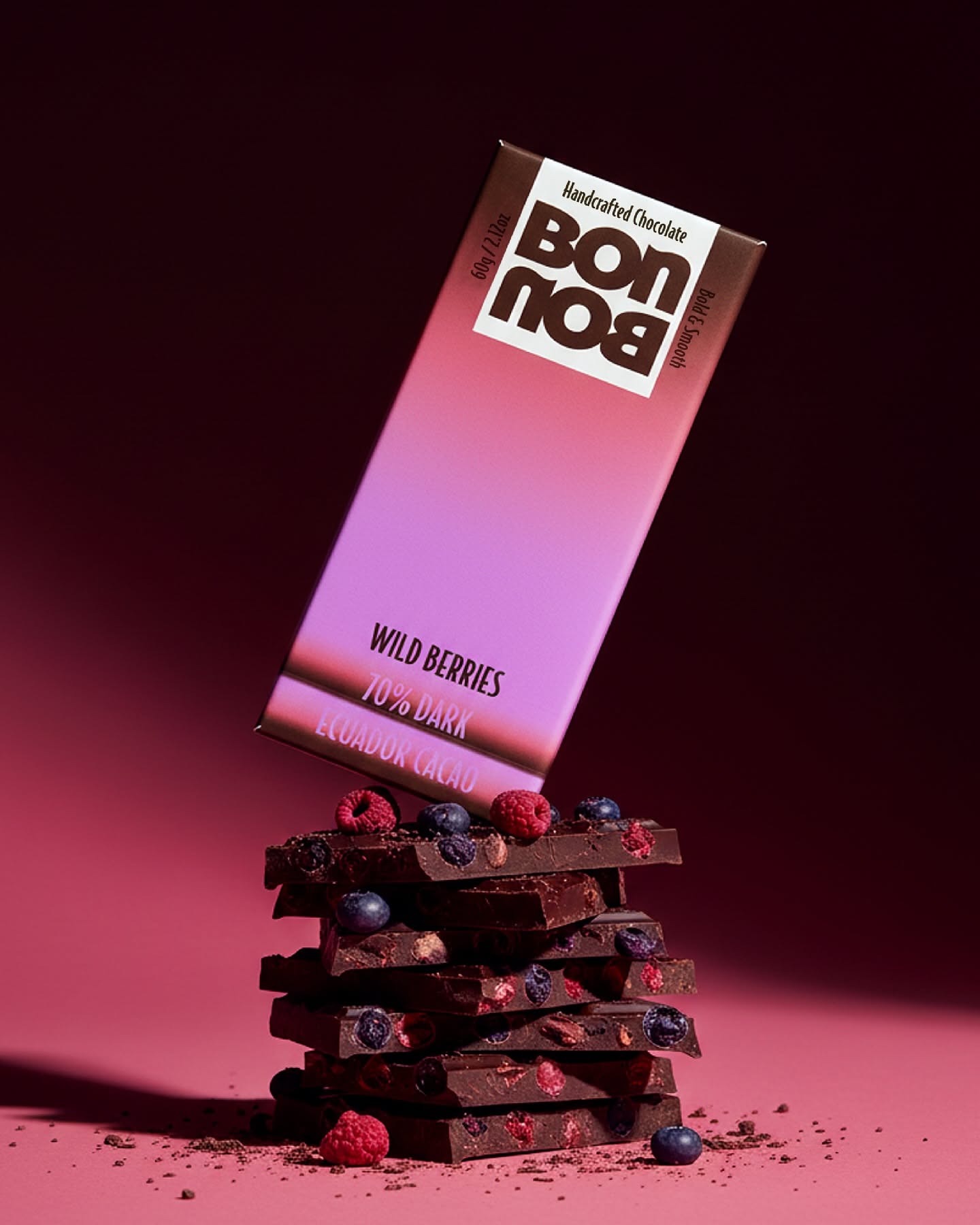 Instagram post: Tilted chocolate bar pack balanced on a stack of berry-studded dark chocolate