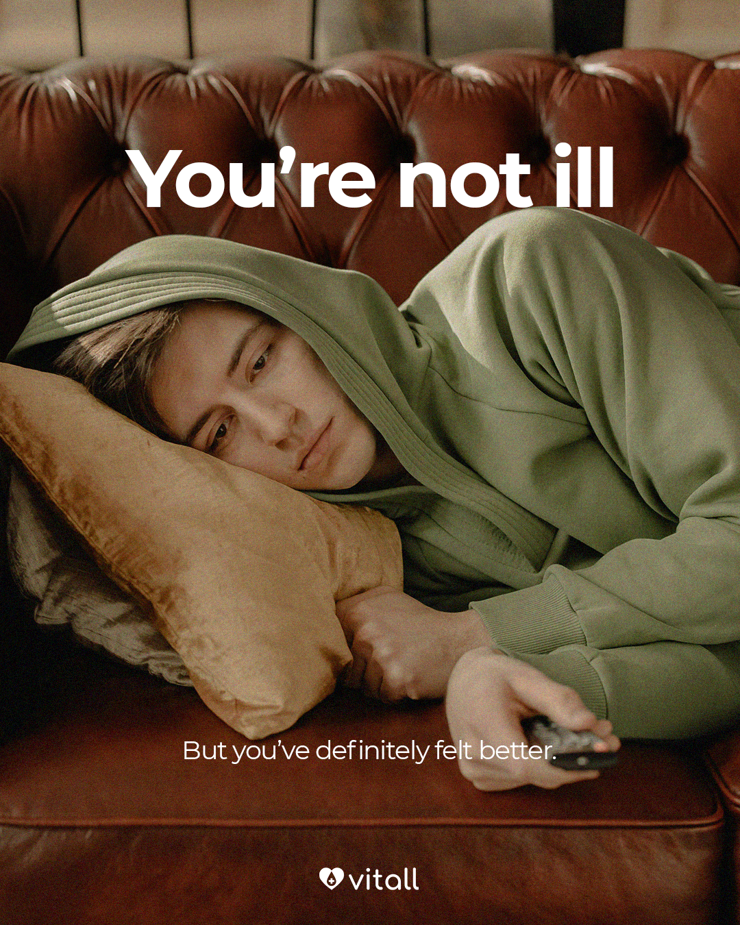 Instagram post: Tired young person in a hoodie lying on a leather sofa