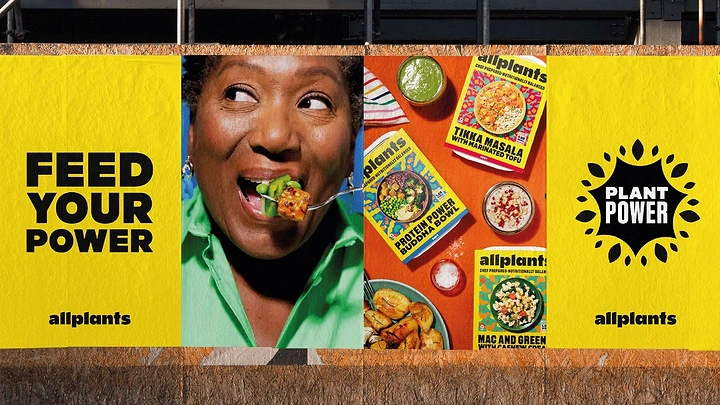 Frozen Foods & Ready-to-Cook creative ad: Woman biting plant-based food beside a flat lay of meal packs