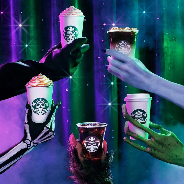 Halloween creative ad: Five branded coffee cups held by costumed monster hands