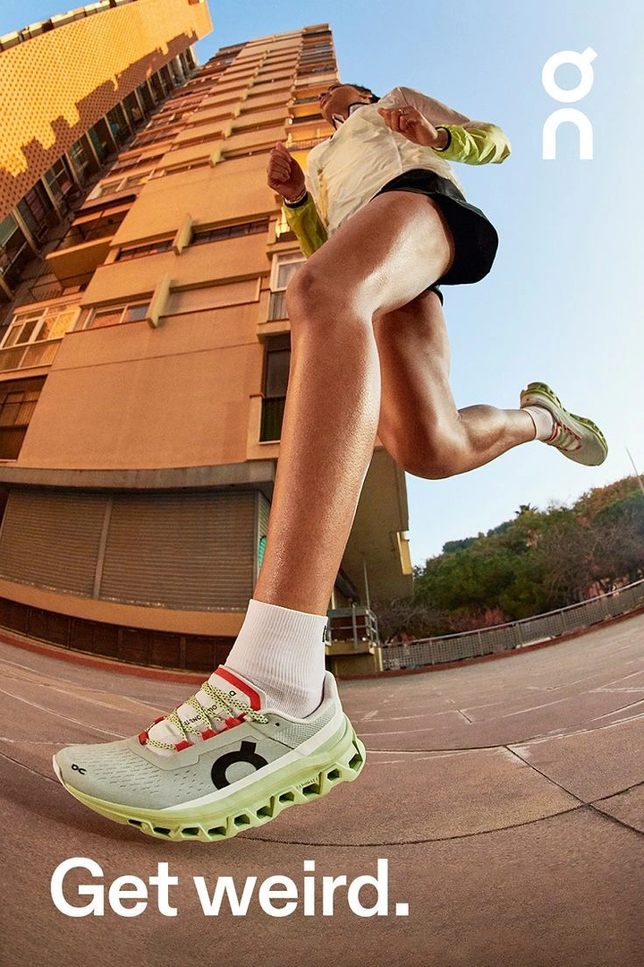 Creative ad: Runner mid-stride shot from an extreme low fisheye angle, sneaker in the foreground