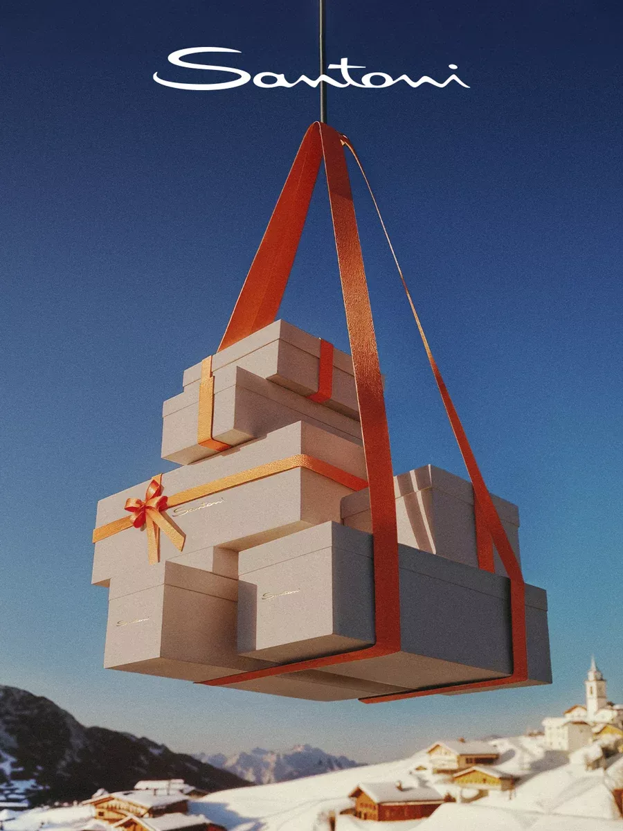 A stack of gift boxes slung in orange ribbon hanging from a cable