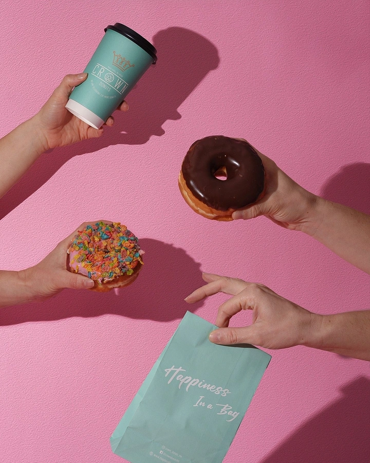 Donut Shops creative ad: Unexpected overhead hands composition