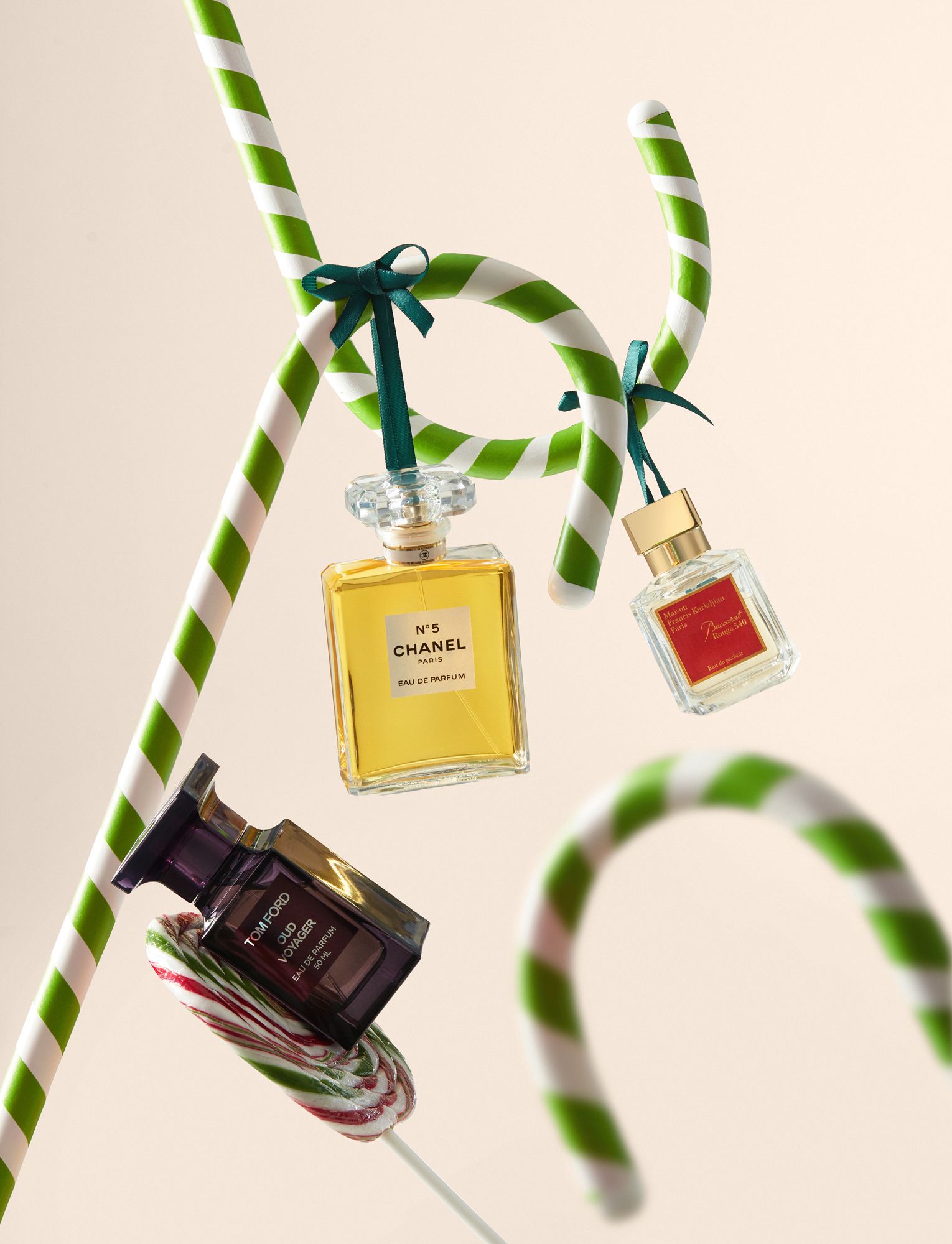 Christmas Instagram post: Perfume bottles hanging from green-and-white candy canes