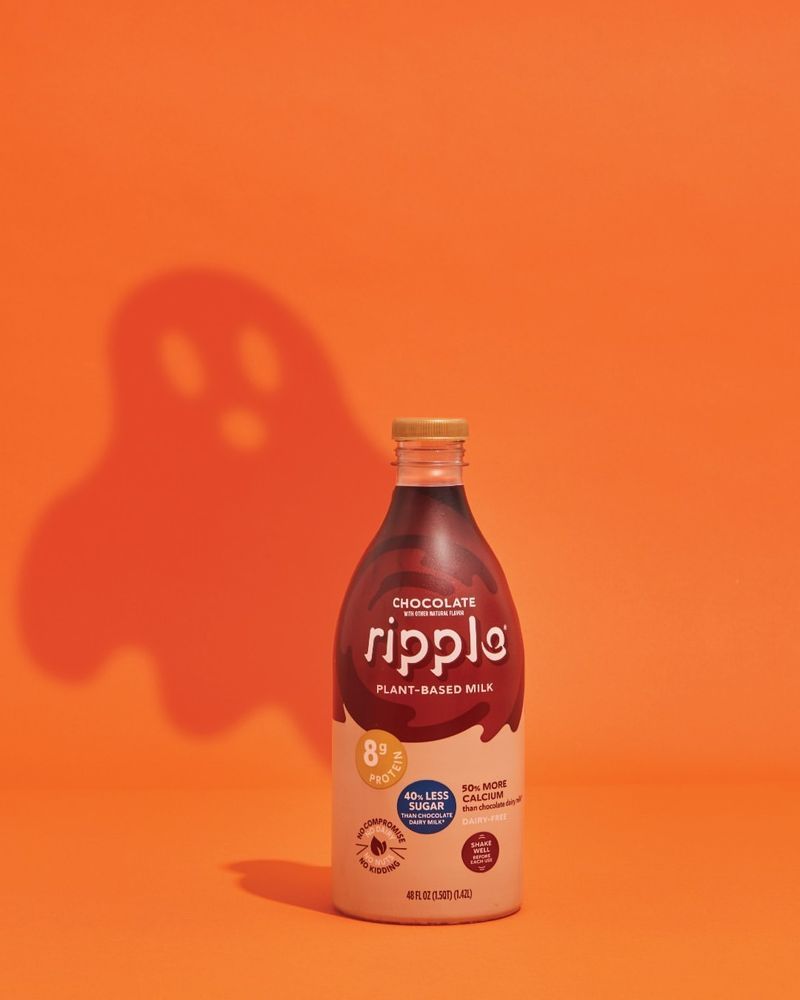 Plant-based milk bottle casting a ghost-shaped shadow