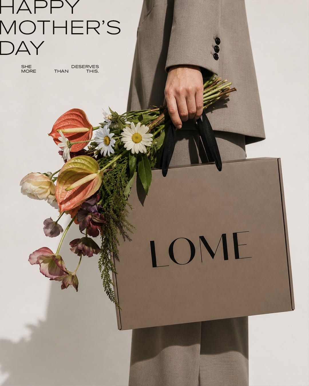 Mother's Day Carousel: Suited figure holding a branded shopping bag and a loose bouquet, slide 1