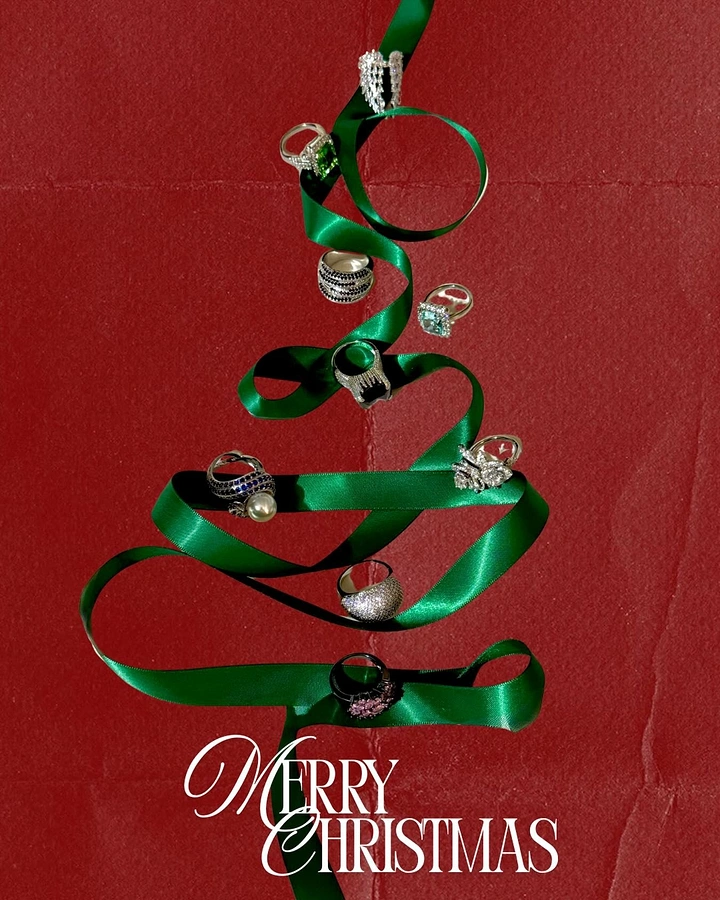 Christmas creative ad: Green satin ribbon zigzagged into a Christmas tree hung with rings