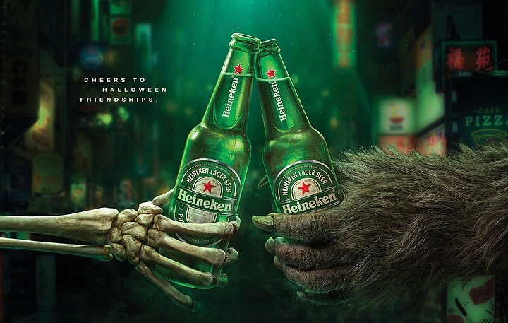 Halloween creative ad: Skeleton hand and werewolf paw clinking beer bottles
