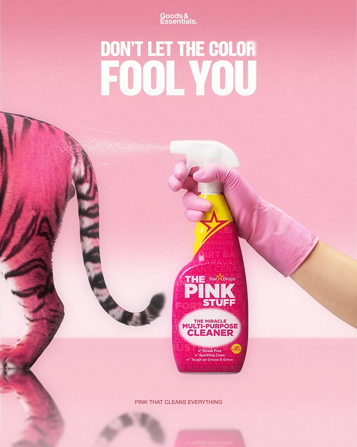 Cleaning Services creative ad: Gloved hand spraying pink cleaner at a pink-striped tiger