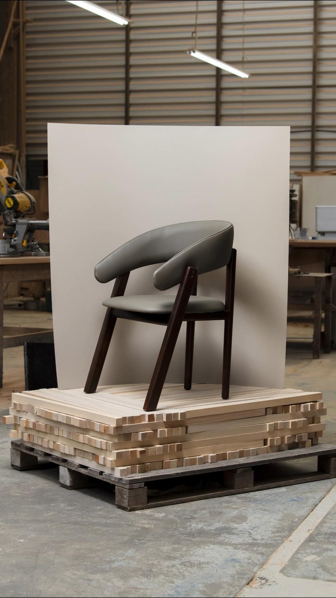 Story: Chair on raw lumber pallet, studio backdrop