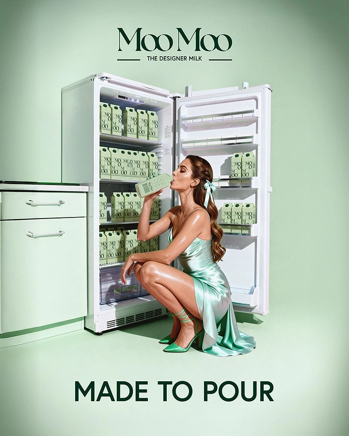 Dairy Brands creative ad: Woman in mint satin dress drinking milk carton at open fridge